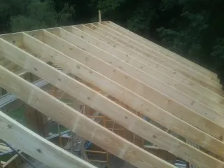 New roof rafters set over an addition before sheathing in Norfolk